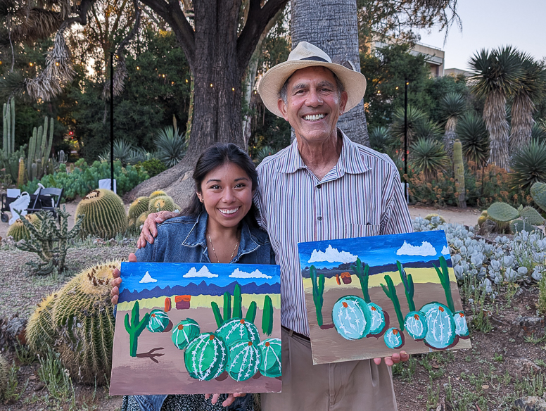 gianna and bob with paintings